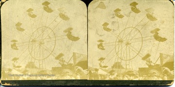 Stereograph image of people riding a ferris wheel.