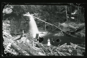 Men, women, and children hike below Douglas Falls in Tucker County, W. Va.