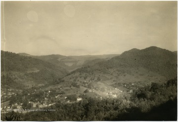 'Webster Springs, the county seat of Webster County, was formerly a thriving health resort well known for its mineral waters. Point Mountain, one of the most scenic ranges in the Alleghanies, rise here at the junction of the Elk River and the Back Fork of the Elk. Bureau of Agricultural Economics Photographs Division Negative Number 18485.'