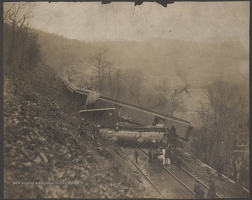 Railroad employees inspect the damage.