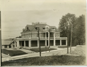 Purinton House built in 1905.  Poster on pole reads, 'Baseball Saturday, May 5'  Note: Trolley car tracks, gas lamp pole.