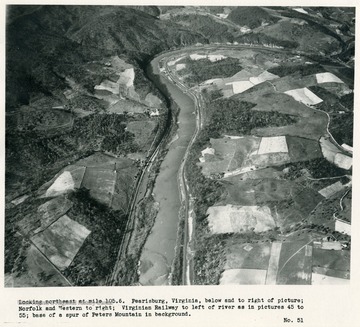 'Looking northeast at mile 105.6.  Pearisburg, Virginia, below and to right of picture; Norfolk and Western to right; Virginian Railway to left of river as in pictures 45 to 55; base of a spur of Peters Mountain in background.'
