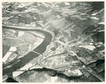 'Glenlyn, Virginia, steam plant of Appalachian electric Power Company (85,000 kw. capacity).  Virginian Railway crosses river and both railroads leave new River and turn westward up East River.  Looking east at mile 94.  Recording gage of Geological Survey located in temporary structure on near side of river just above new four-span steel highway bridge which was erected about 1930, and from which current meter measurements are made.'