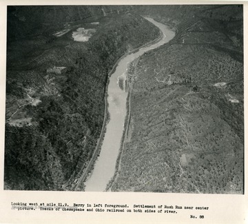 'Looking west at mile 21.9.  Berry in left foreground.  Settlement of Rush Run near center of picture.  Tracks of Chesapeake and Ohio railroad on both sides of river.'