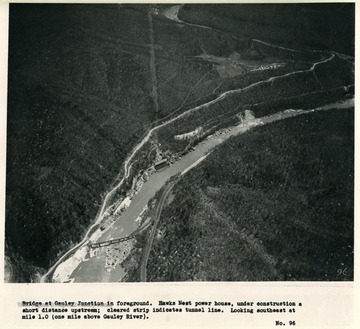 'Bridge at Gauley Junction in foreground.  Hawks Nest power house, under construction a short distance upstream; cleared strip indicates tunnel line.  Looking southeast at mile 1.0 (one mile above Gauley River).'