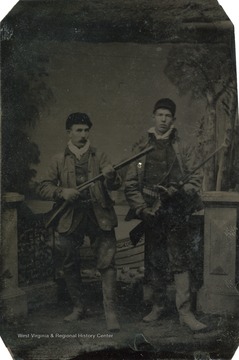 A portrait of two men holding rifles.