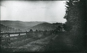 '51.W.23; Wed., July 16 after 6 P.M.' A landscape of a mountain range and a country road, with a carriage in the distance.