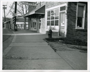 The stores were on West Main Street at the bridge in mid-town Bridgeport. The barber shop was owned by Bill Mick.