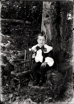 A portrait of Herbert Shock near a chair in Helvetia, W. Va.