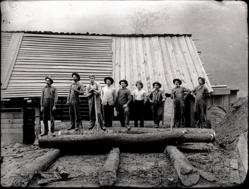Loggers line up along the lumber mill in Helvetia, W. Va.