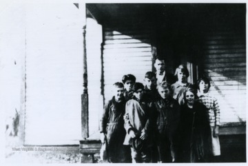 A group of Mt. View School students stand in front of the school house with their teacher, Joseph Lyons.