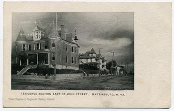 Postcard print of large homes with several turrets, window dormers and chimneys.