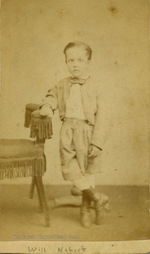 A carte de visite of a young boy dressed in his best "bib and tucker".
