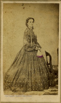 This carte de visite has a federal revenue stamp on the back indicating a tax was paid on the photograph. This tax was passed by Congress, 1864-1866, to pay for the war. The young woman is wearing the fashion and hair style of the Civil War period.