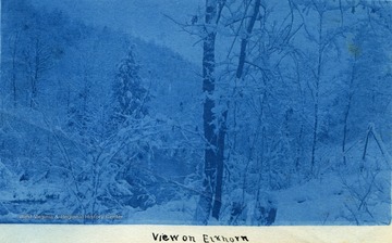 Snow-covered mountains and terrain along Elkhorn Creek, a tributary of Tug Fork River. The photograph was taken during the construction on the Ohio extension of the Norfolk &amp; Western Railroad. 