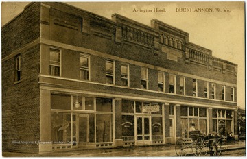 Postcard photograph of the Arlington Hotel with a horse and buggy parked outside. See back of the original image for correspondence. 