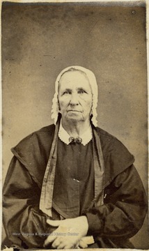 Unidentified older woman wearing a dress and bonnet. 