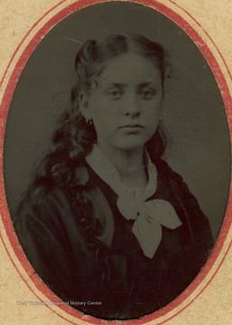 A young woman identified as Annie B. Baldwin. The name "William A. Gatentin" is written on the back of the image.