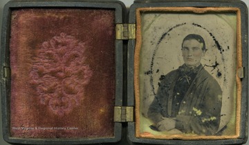 Cased ambrotype photograph of an unidentified young man. The emulsion of this fragile image is beginning to fall off the plate. Ambrotypes were popular in the mid-1800's