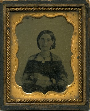 Possibly a tintype of a young woman wearing the style of dress and hair for the Civil War era.