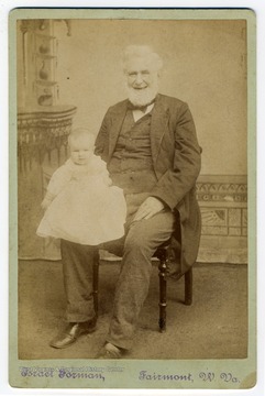 Portrait of a smiling, elderly Governor Francis H. Pierpont holding an unidentified infant. Pierpont served as the Governor of the Restored Government of Virginia which was loyal to the Union during the Civil War. He is known as "The Father of West Virginia"
