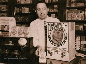 Caption on postcard reads: "premium products were very popular with Mail pouch. Pictured here is a store clerk with a table radio."