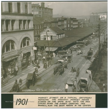 The caption describes the scene as "Market Street on a typical Saturday morning. The present Market House stands on the same site. Note the man coming down the street carrying two barrels also the beer wagon in the center."