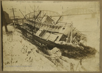 Photo of a wrecked steamboat in the frozen river.