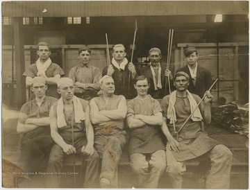 A group of unidentified men holding glass cutting tools and equipment.