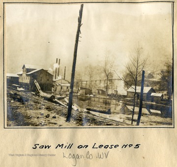 A lumber mill pond feeds the logs into the saw mill.