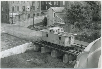 A train car sits on the railroad track. 