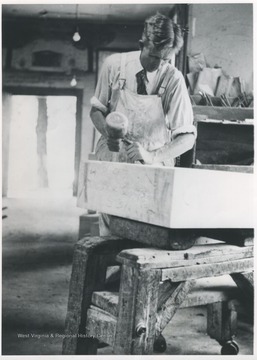 Loomis at work in his shop located on Front Street. Loomis carved most of the stones that grace the graves of pioneer railroaders that settled in Hinton in its infancy. Loomis died in 1936.