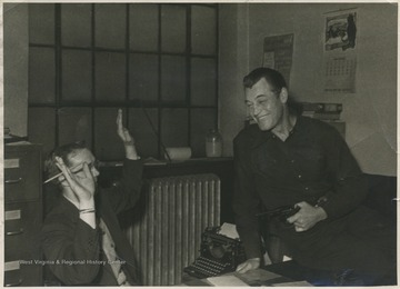 Starret, posing on the right, points a gun at an unidentified newspaper employee. Starret played many roles in old western movies. 