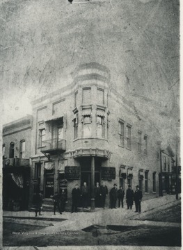 The bank staff pose in front of the building located on 3rd Avenue. Subjects unidentified. 