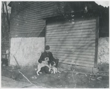Murrell pictured with two dogs outside his house located on the corner of 5th Avenue and Summers Street. 
