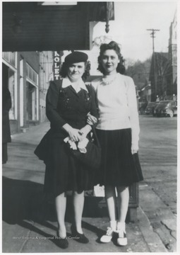 Lona Richmond, left, and Betty Jane Arrington Angell, right, pose in front of the theatre on Ballengee Street. 