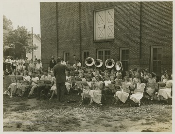 A band comprised of young musicians play outside Summers Memorial Building. 