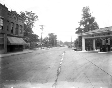 Esso Standard Oil Gasoline Station to the right and Kanawha Cash Grocery Store to the left.