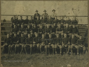 Football players sit along the bleachers for their team portrait. Subjects unidentified. 