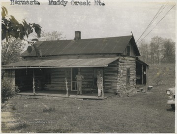 Two unidentified men are pictured under the cabin's awning. 