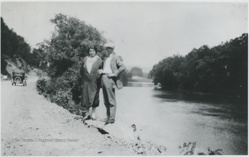 The two unidentified persons pose beside the river on what is now Route 3 below Alderson, W. Va. 