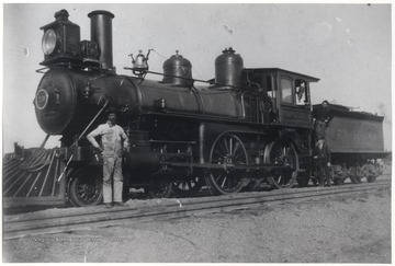 Legendary engineer, Richardson, pictured in white coveralls, poses next to new American engine No. 70 after a run from Hinton. 