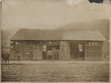Two unidentified men and a small African-American boy stand by a horse outside of the wooden building. Here is the location where the Hinton Presbyterian Church is currently.