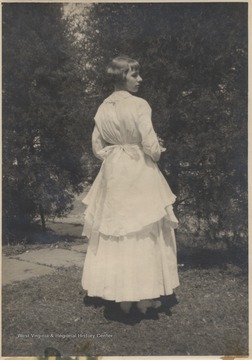 Hinton pictured in the oldest wedding dress in Hinton, which was first worn on December 27, 1871 when Mary Jane Charlton married Galon Silas Hinton.