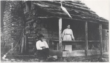 Ballengee and his wife pictured outside of their log home in the Avis section of town. 