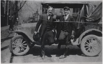 Two unidentified men pose by the intersection of Ballengee Street and 3rd Avenue. 