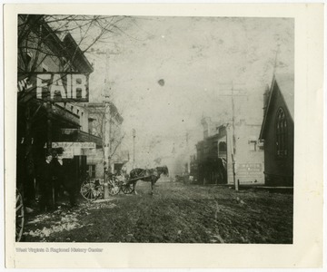 Looking West on Temple St.  Episcopal church to the right, Independent Herald Office to the left along with Fair.