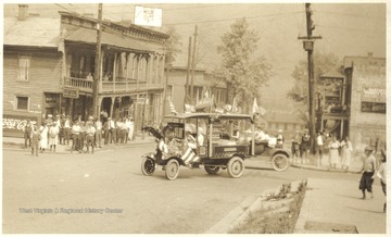 An old automobile decorated with American flags is pictured at the intersection of 3rd Avenue and Temple Street. 