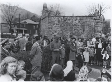 A man speaks to the crowd gathered at the memorial on the day of the Army Day Parade. Subjects unidentified. 