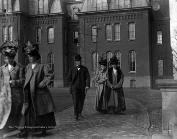 Early twentieth century students walking away from Woodburn Hall likely between classes at West Virginia University.
